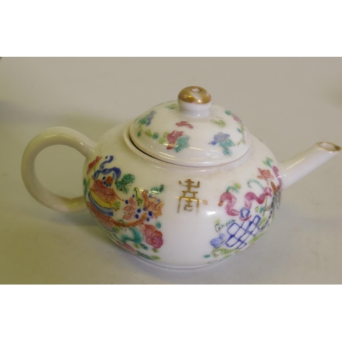 298 - A Chinese porcelain miniature teapot decorated in enamels with inscriptions, 9cm high, a famille ros... 