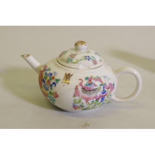 298 - A Chinese porcelain miniature teapot decorated in enamels with inscriptions, 9cm high, a famille ros... 