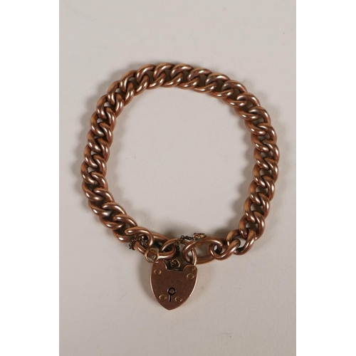 603 - A 9ct rose gold chain link bracelet with heart shaped padlock clasp, 15.2g