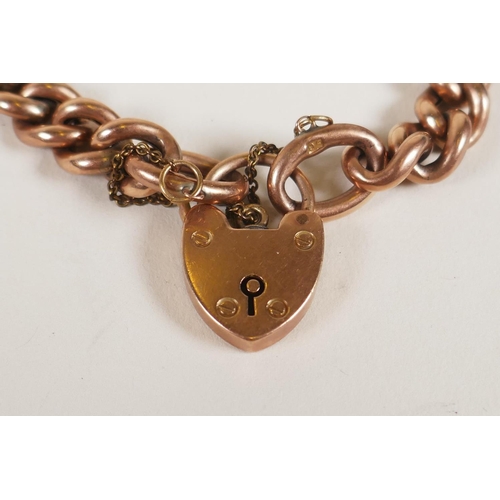 603 - A 9ct rose gold chain link bracelet with heart shaped padlock clasp, 15.2g