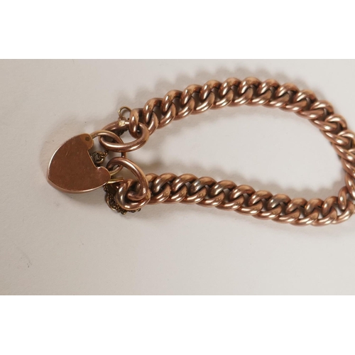 603 - A 9ct rose gold chain link bracelet with heart shaped padlock clasp, 15.2g