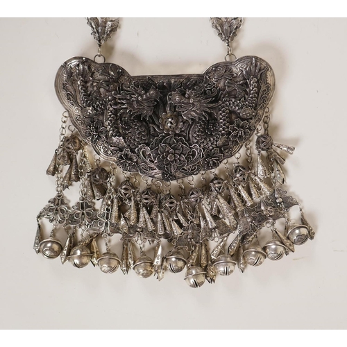 606 - A Chinese white metal 'Hmong' charm necklace with filigree decoration of dragons and flowers, 19cm w... 