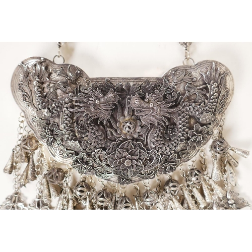 606 - A Chinese white metal 'Hmong' charm necklace with filigree decoration of dragons and flowers, 19cm w... 