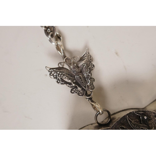 606 - A Chinese white metal 'Hmong' charm necklace with filigree decoration of dragons and flowers, 19cm w... 