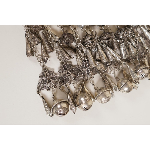606 - A Chinese white metal 'Hmong' charm necklace with filigree decoration of dragons and flowers, 19cm w... 