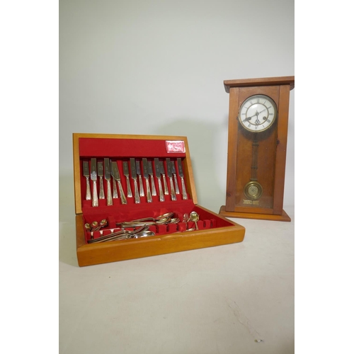 665 - A Sheffield silver plated eight place cutlery service in canteen, and a Vienna wall clock in later c... 