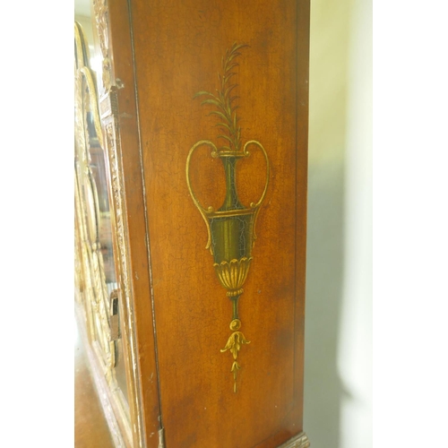 1001 - A C19th satinwood Sheraton Revival cabinet in two sections, with painted and parcel gilt decoration,... 