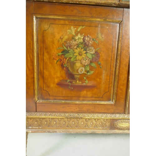 1001 - A C19th satinwood Sheraton Revival cabinet in two sections, with painted and parcel gilt decoration,... 