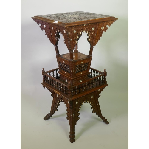 1007 - A Moorish hardwood table/stand, with carved decoration and mother of pearl inlay, decorated with Isl...