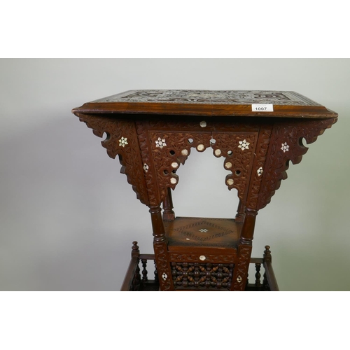 1007 - A Moorish hardwood table/stand, with carved decoration and mother of pearl inlay, decorated with Isl... 