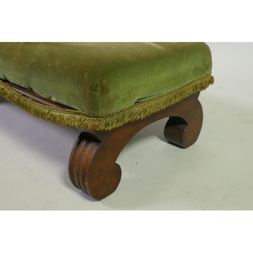 1034 - A C19th mahogany fender stool, raised on scroll supports, 125 x 34 x 24cm