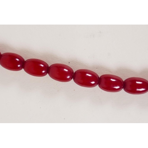 614 - A vintage graduated cherry amber necklace, 82cm long, 81g