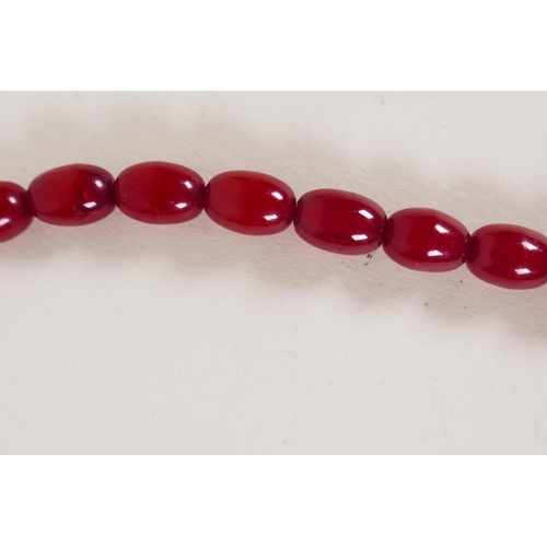 614 - A vintage graduated cherry amber necklace, 82cm long, 81g