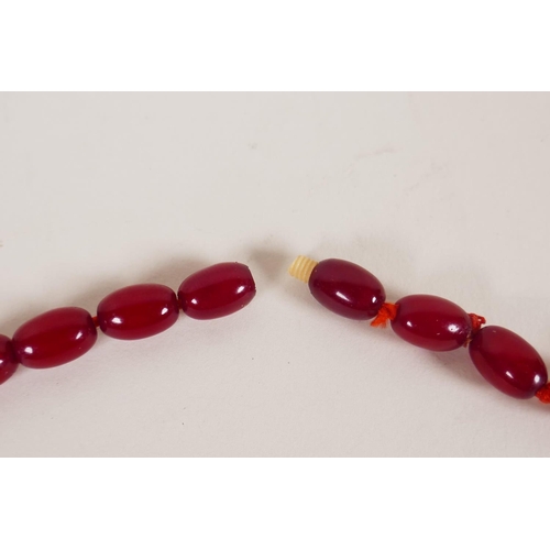 614 - A vintage graduated cherry amber necklace, 82cm long, 81g