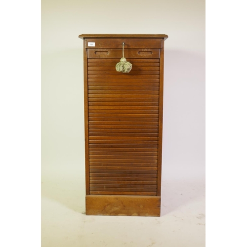 1004 - Early C20th oak office filing cabinet with tambour front and nine slide drawers, 50 x 53 x 110cm