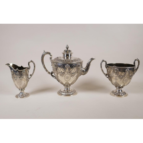 602 - A fine Victorian silver three piece tea set by Martin, Hall &amp; Co, London, 1876, decorated with r...