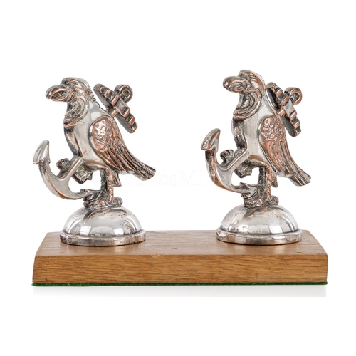 282 - A PAIR OF BANDMASTER'S MUSIC STAND FINIALS FROM H.M.S. HOOD, CIRCA 1920
modelled as the ship's badge... 