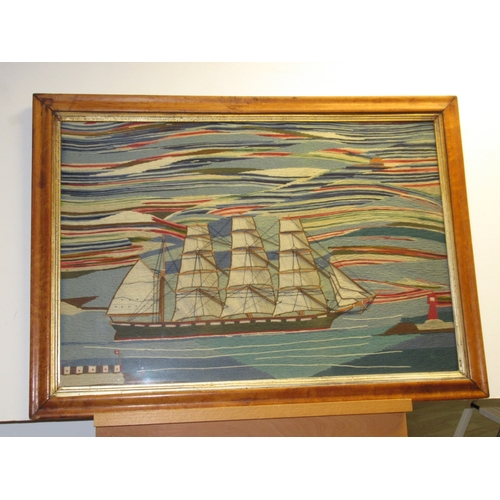 20 - A LARGE 19TH CENTURY SAILOR'S WOOLWORK PICTURE
depicting a barque under full sail off a headland wit... 