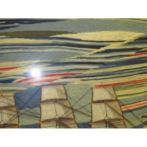 20 - A LARGE 19TH CENTURY SAILOR'S WOOLWORK PICTURE
depicting a barque under full sail off a headland wit... 