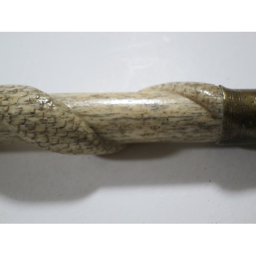 28 - Ø A SAILOR'S WHALEBONE WALKING STICK, CIRCA 1860the shaft carved with two entwined serpents meeting,... 