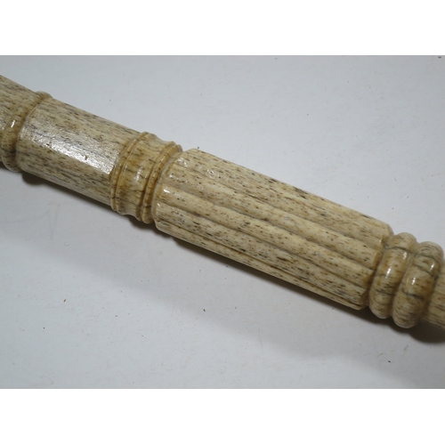 28 - Ø A SAILOR'S WHALEBONE WALKING STICK, CIRCA 1860the shaft carved with two entwined serpents meeting,... 