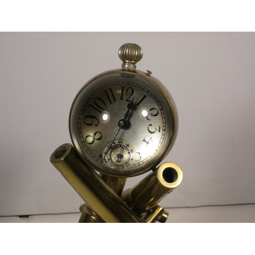 153 - A NOVELTY DESK CLOCK, CIRCA 1900formed as three cannon barrels supporting a 2½in. diameter glass glo... 