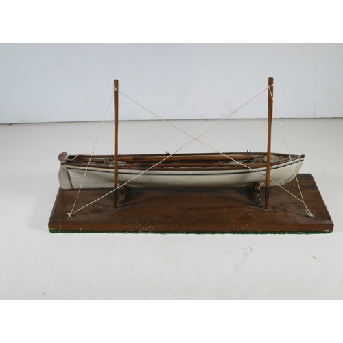 15 - 19TH CENTURY SAILOR-TYPE MODEL FOR A CORNISH PILOT GIG with 11in. hull carved from the solid and con... 