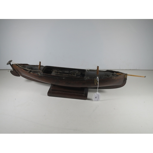 18 - AN ATTRACTIVE MODEL OF A LUG-RIGGED, DROP-KEEL CANOE, CIRCA 1890the 19in. carved hull carved from th... 