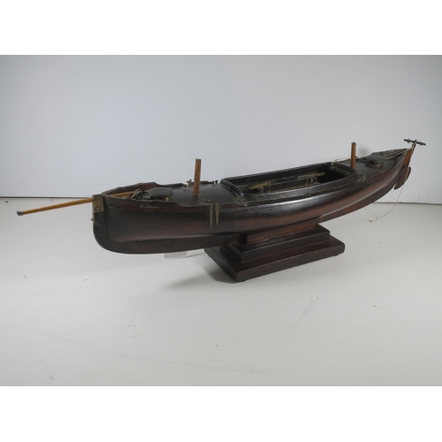 18 - AN ATTRACTIVE MODEL OF A LUG-RIGGED, DROP-KEEL CANOE, CIRCA 1890the 19in. carved hull carved from th... 