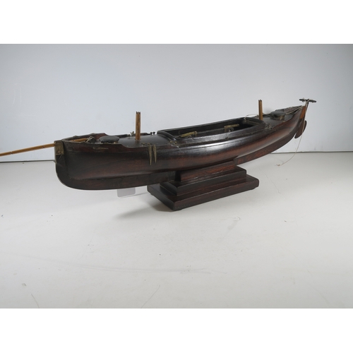 18 - AN ATTRACTIVE MODEL OF A LUG-RIGGED, DROP-KEEL CANOE, CIRCA 1890the 19in. carved hull carved from th... 