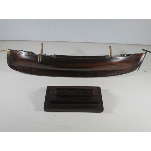 18 - AN ATTRACTIVE MODEL OF A LUG-RIGGED, DROP-KEEL CANOE, CIRCA 1890the 19in. carved hull carved from th... 