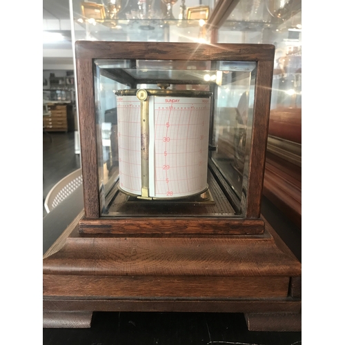 231 - A RECORDING BAROGRAPH RETAILED BY HARRODS, LONDON, CIRCA 1920oak case with ivorine retailer's plate,... 