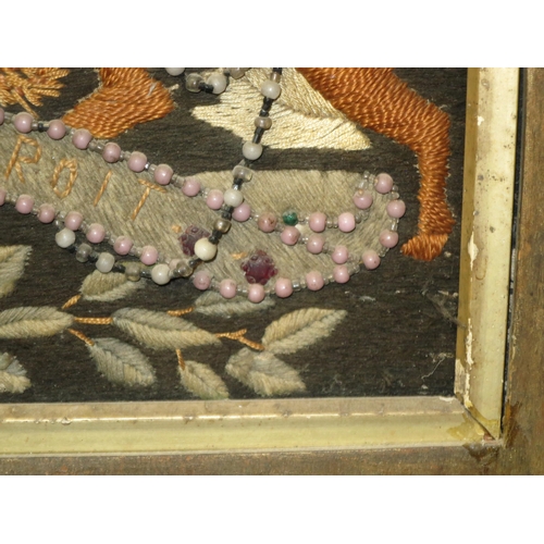 181 - A 19TH CENTURY SAILOR'S WOOLWORK PICTURE AND FRAME
depicting the Royal Arms with raised silkwork lio... 