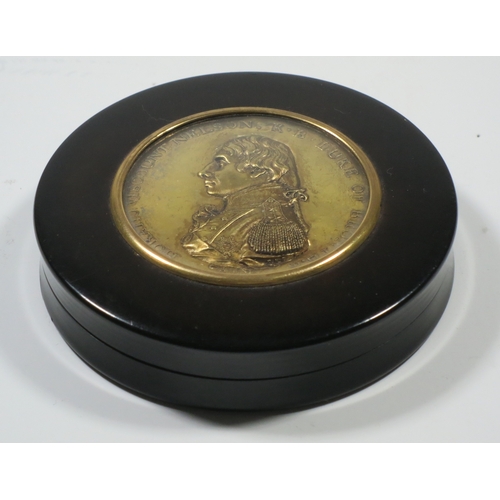 162 - A CIRCULAR TORTOISESHELL SNUFF BOX COMMEMORATING ADMIRAL LORD NELSON, CIRCA 1805
the lid set with an... 