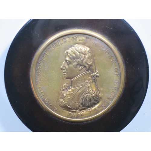 162 - A CIRCULAR TORTOISESHELL SNUFF BOX COMMEMORATING ADMIRAL LORD NELSON, CIRCA 1805
the lid set with an... 