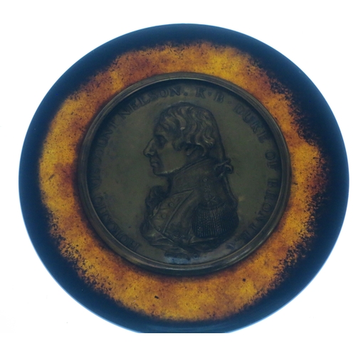 162 - A CIRCULAR TORTOISESHELL SNUFF BOX COMMEMORATING ADMIRAL LORD NELSON, CIRCA 1805
the lid set with an... 