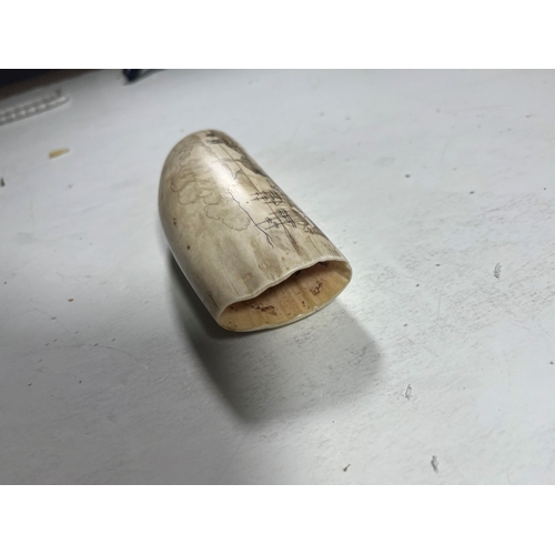 11 - Ø AN EARLY 20TH CENTURY SCRIMSHAW WHALE TOOTH
depicting a panoramic view of a port town, with the su... 