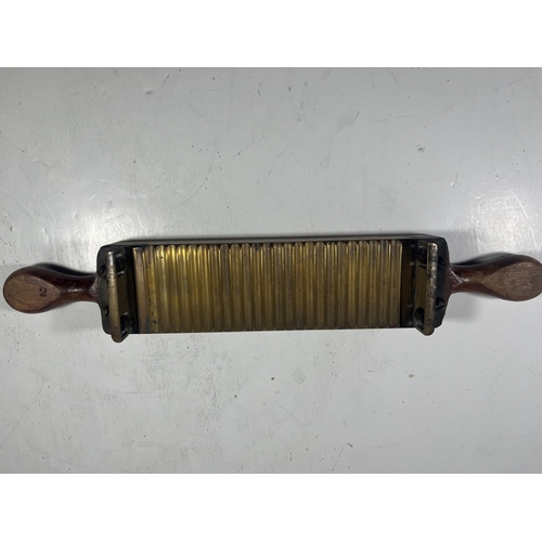 140 - A 19TH CENTURY PILL MACHINE
of typical form, brass mounted, with roller -- 16½in. (42cm.) widetwo cr... 