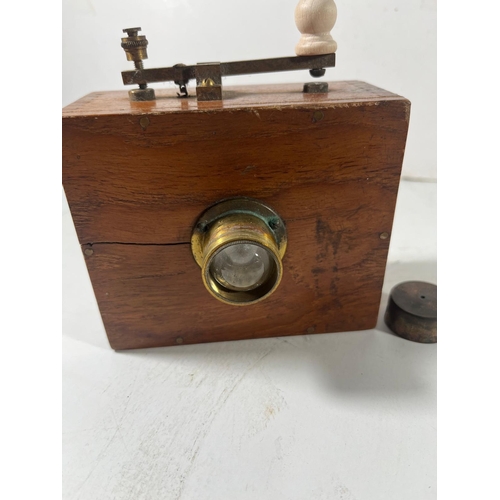 160 - A WOODEN BRASS MORSE LAMP FOR A YACHT, CIRCA 1920
with small bullseye lens, lacquered brass relay ar... 