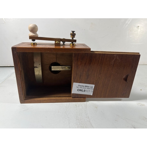 160 - A WOODEN BRASS MORSE LAMP FOR A YACHT, CIRCA 1920
with small bullseye lens, lacquered brass relay ar... 