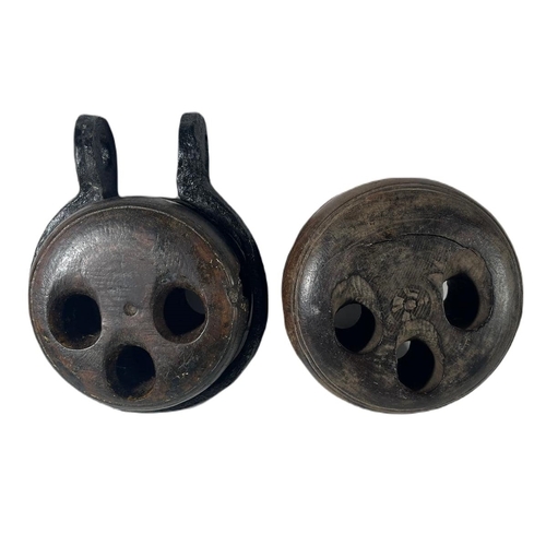 33 - TWO 19TH CENTURY DEADEYES
carved from lignum vitae, one with iron rim -- 6.5in. (16.5cm.) diam. ea.... 