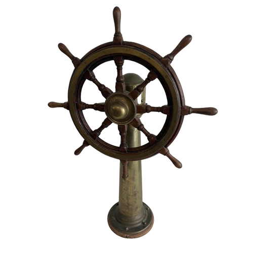 41 - AN EIGHT-SPOKE SHIP'S HELM, 20TH CENTURY
a brass-bound ship's helm mounted on tapered brass pillar s... 