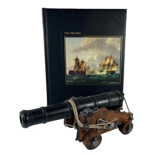 83 - A MODERN MODEL OF AN 18TH CENTURY NAVAL GUN
with metal barrel on a stepped wooden carriage with wood... 