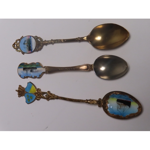 154 - A COLLECTION OF OCEAN LINER SILVER, ENAMEL AND SILVER-PLATED SHIPS' SOUVENIR SPOONS
comprising Imper... 