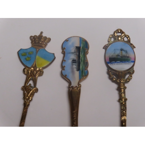 154 - A COLLECTION OF OCEAN LINER SILVER, ENAMEL AND SILVER-PLATED SHIPS' SOUVENIR SPOONS
comprising Imper... 