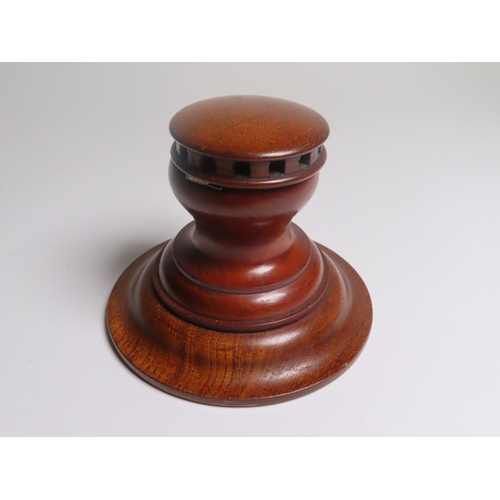 29 - AN INKWELL MADE FROM H.M.S. BRITANNIA TREEN
modelled as a capstan, with ceramic liner and brass prov... 