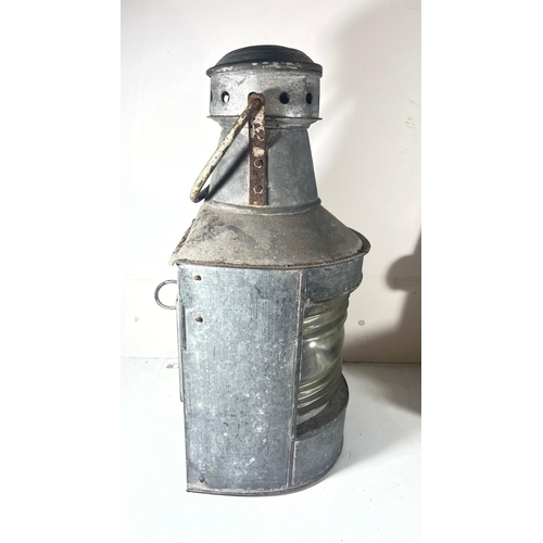 91 - A MASTHEAD LAMP, 20TH CENTURY
galvanised tin with Fresnel-type lens, complete with burner -- 19in. (... 