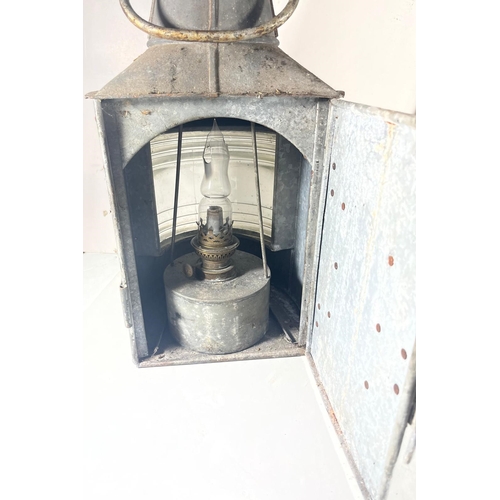 91 - A MASTHEAD LAMP, 20TH CENTURY
galvanised tin with Fresnel-type lens, complete with burner -- 19in. (... 