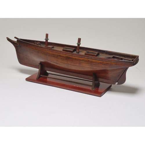 16 - A 19TH CENTURY CARPENTER'S MODEL FOR A TWO-MASTED YACHT
with planked and pinned 19in. hull and decks... 