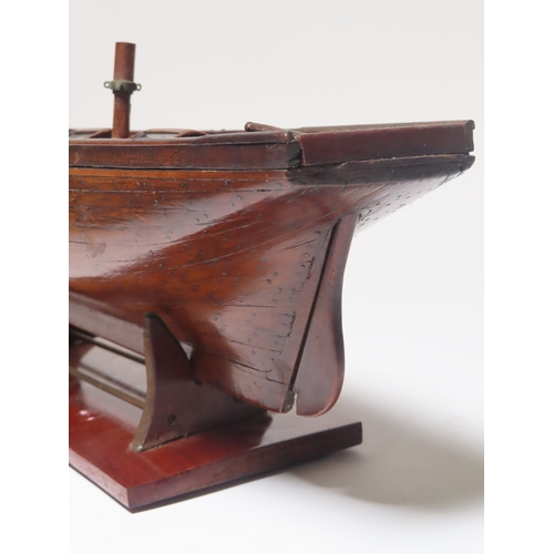 16 - A 19TH CENTURY CARPENTER'S MODEL FOR A TWO-MASTED YACHT
with planked and pinned 19in. hull and decks... 